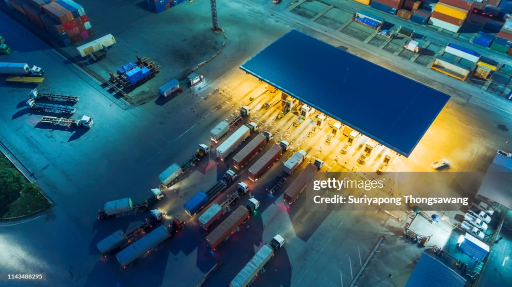 Aerial view container truck waiting at check point or terminal for unload container at container warehouse for logistics, import export, shipping or transportation.