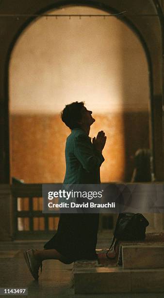 Ruza Batkovic prays during mass in a church on Sarajevo's Sniper Alley Sunday Oct. 8, 1995. Sarajevo citizens are looking forward to the return of...
