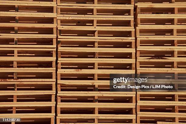 stacked wooden pallets - edmonton industrial stock pictures, royalty-free photos & images