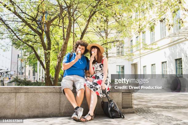 couple eating ice cream outdoors in city - tourism life in bavaria foto e immagini stock