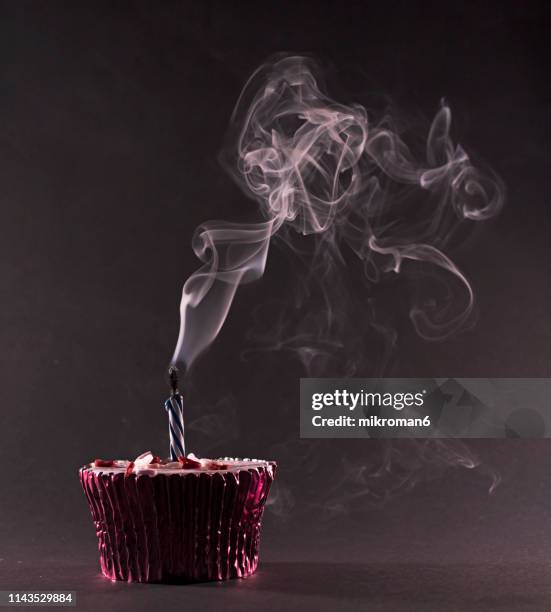 birthday candles blown out. happy birthday cupcakes - birthday candle on black stock pictures, royalty-free photos & images