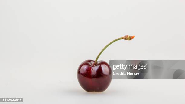 closeup of ripe cherry on white cackground - cherries stockfoto's en -beelden