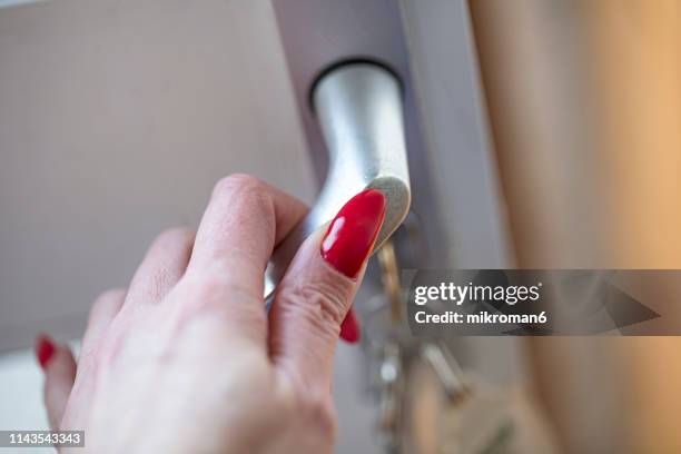 female hand on door handle - hands on a hard body stock pictures, royalty-free photos & images