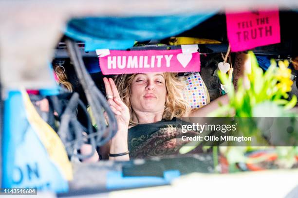 An Extinction Rebellion environmental activist locked to the underneath of a truck used for live music performances during the occupation of Waterloo...