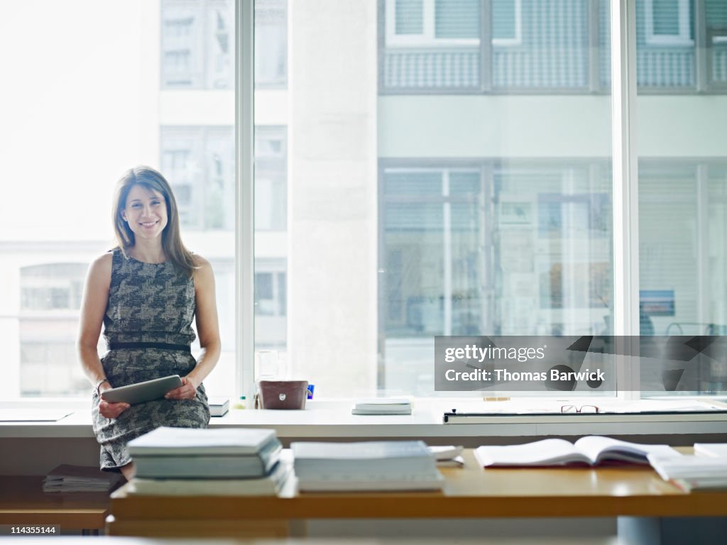 Portrait of businesswoman holding digital tablet
