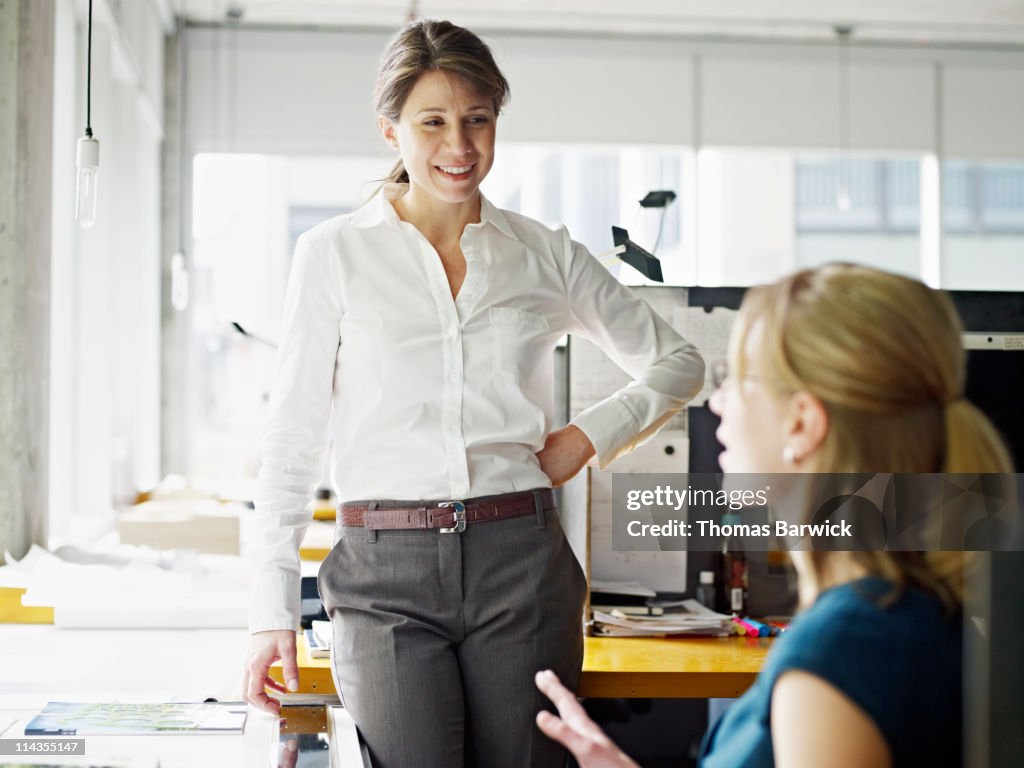 Two businesswomen in discussion in workstation