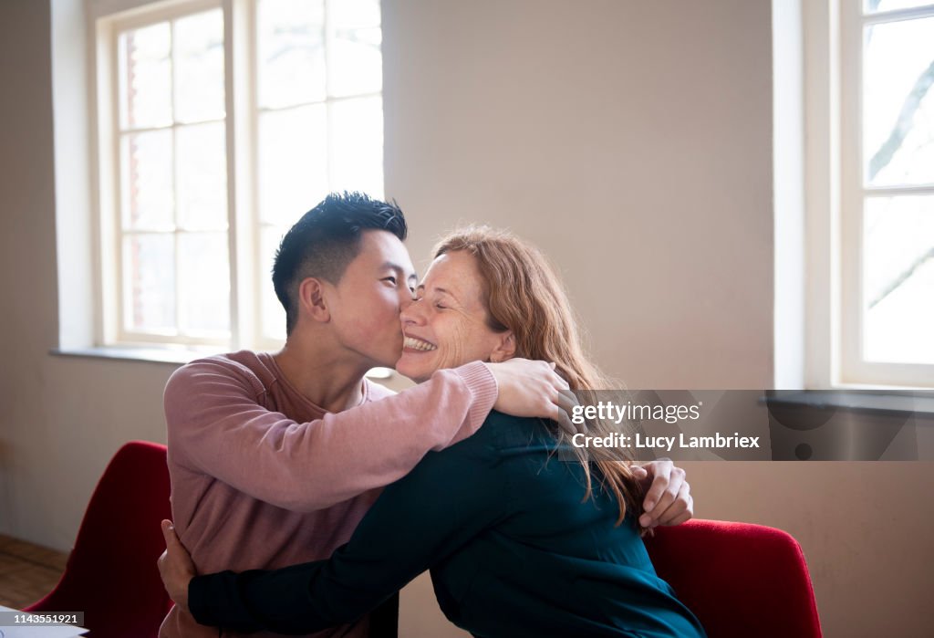 Mother and son embracing