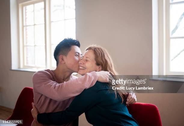 mother and son embracing - teenagers kissing stock pictures, royalty-free photos & images