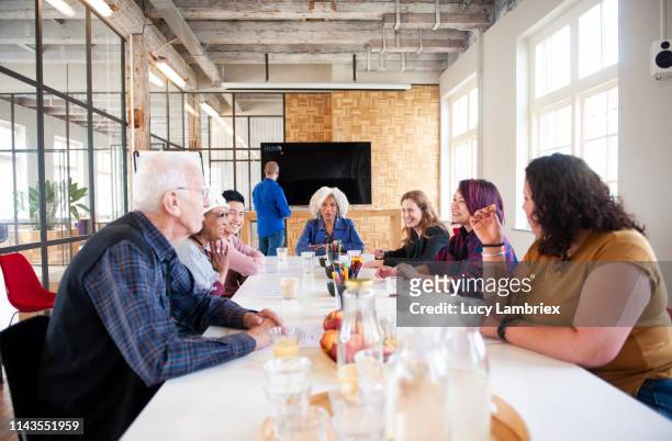 mixed team waiting for the monitor to be set up at a hand lettering workshop - senior colored hair stock pictures, royalty-free photos & images