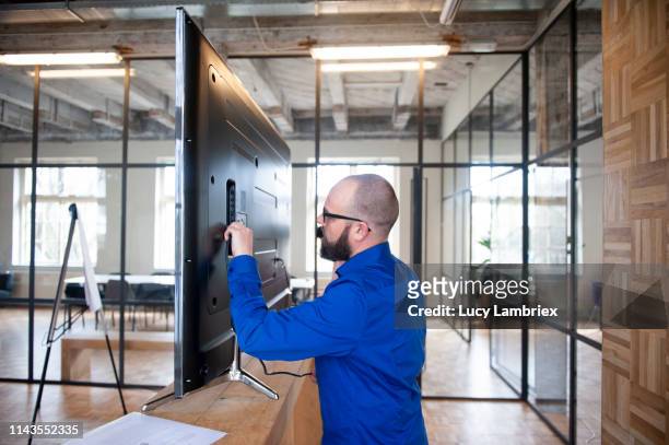 man trying to get the monitor to work for his presentation - bt stock pictures, royalty-free photos & images