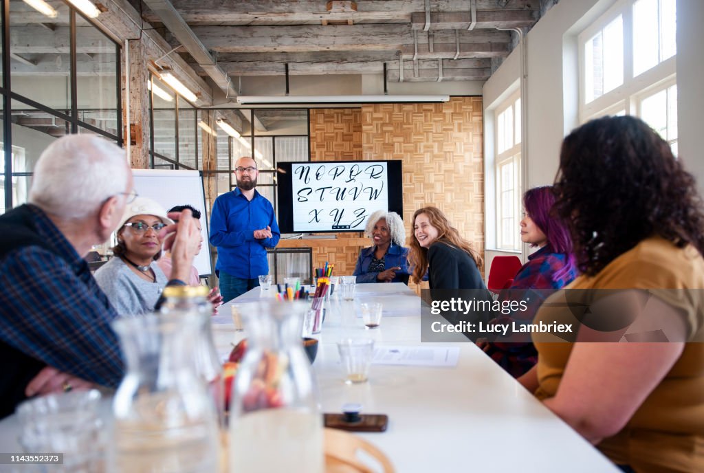 Mixed Group Of People Talking To The Instructor At A Hand Lettering ...