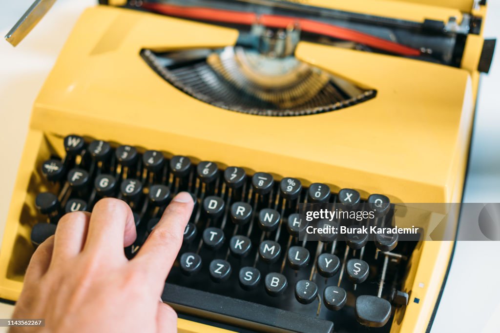 Human Hands Typing On Yellow Vintage Type Writer Machine High-Res Stock ...