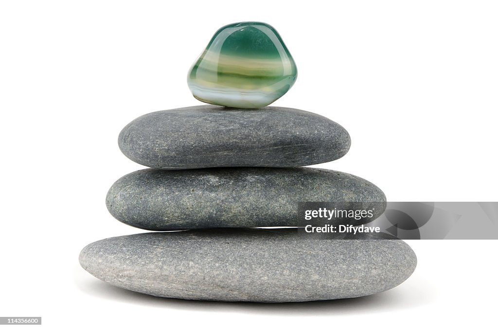 Green Aventurine Gemstone On Piled Black Stones