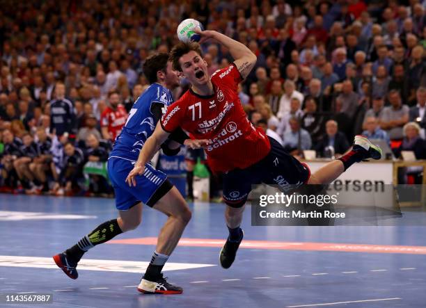 Magnus Roed of Flensburg challenges Marvin Sommer of Gummersbach during the DKB HBL match between SG Flensburg-Handewitt and VfL Gummersbach at...