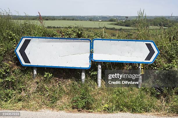 two blank road signs pointing in opposite directions - highway sign stock pictures, royalty-free photos & images