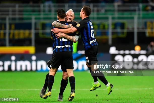 Inter's Italian forward Matteo Politano celebrates with teammates Belgium midfielder Radja Nainggolan and Portuguese defender Cedric Soares after...