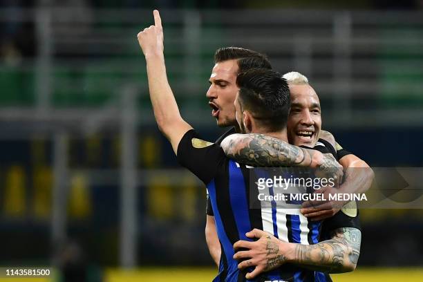 Inter Milan's Italian forward Matteo Politano is congratulated after scoring a goal by teammates Inter Milan's Belgium midfielder Radja Nainggolan...