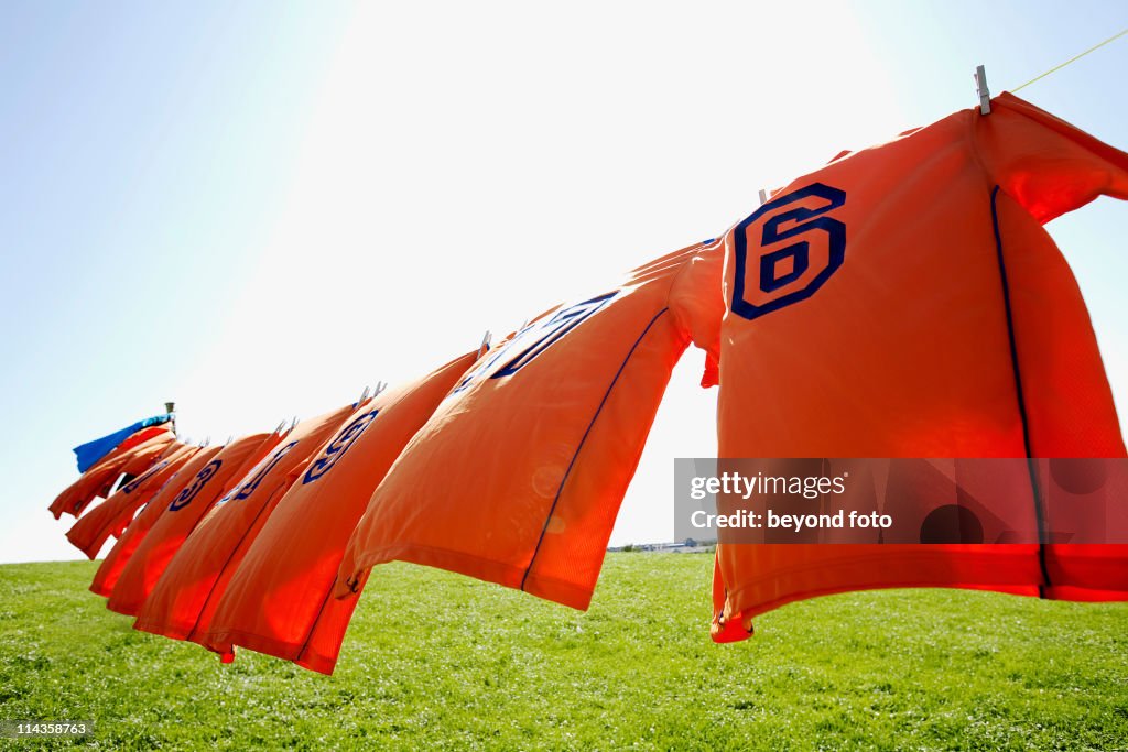Football dresses hanging on clothesline
