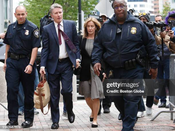 Actress Felicity Huffman, center, enters the John Joseph Moakley United States Courthouse with her brother Moore Huffman Jr., second from left, in...