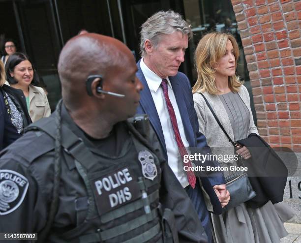 Actress Felicity Huffman, right, leaves the John Joseph Moakley United States Courthouse with her brother Moore Huffman Jr., center, in Boston on May...