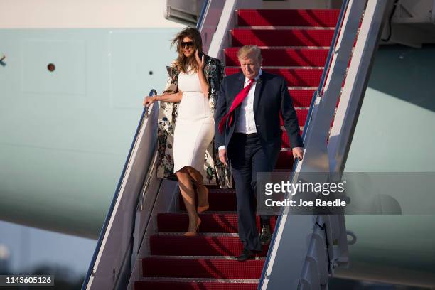 President Donald Trump and First Lady Melania Trump step from Air Force One at the Palm Beach International Airport to spend Easter weekend at his...