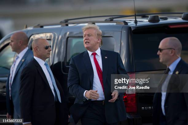 President Donald Trump talks with supporters after arriving on Air Force One at the Palm Beach International Airport to spend Easter weekend at his...