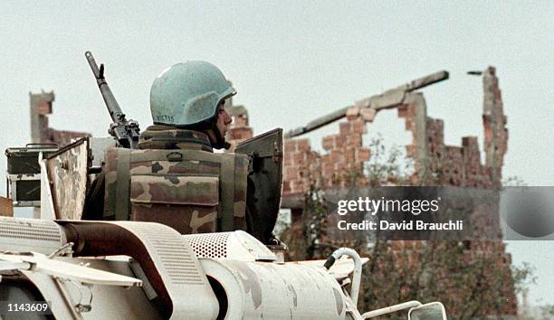 French United Nations soldier atop his APC keeps an eye out for snipers Monday Oct. 30, 1995 as his comrades remove dirt barricades and look for land...