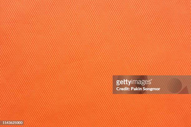 close up orange colour fabric texture. textile background. - fond orange photos et images de collection