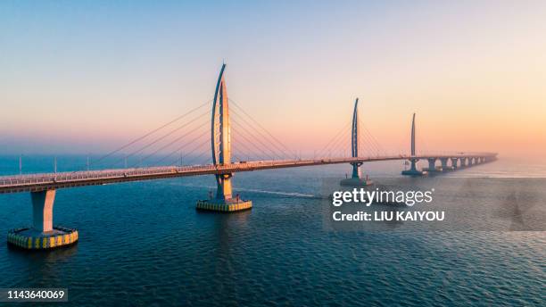 huge bridge with beautiful sunset hong kong-zhuhai-macau bridge - macao fotografías e imágenes de stock