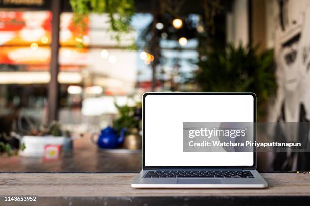 laptop on the table with coffee shop background. save path. - mac laptop stock pictures, royalty-free photos & images