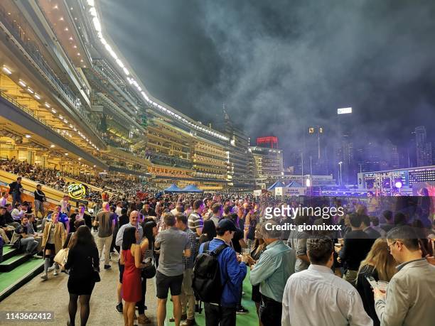 crowd at happy valley racecourse, hong kong island - hong kong races happy valley stock pictures, royalty-free photos & images