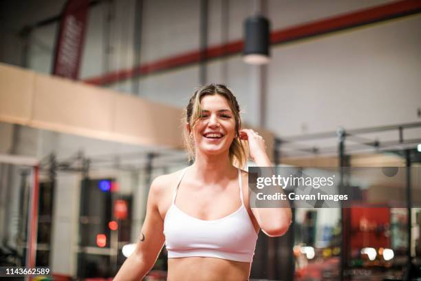 portrait of a woman smiling after a work out - beautiful woman and tired stock pictures, royalty-free photos & images