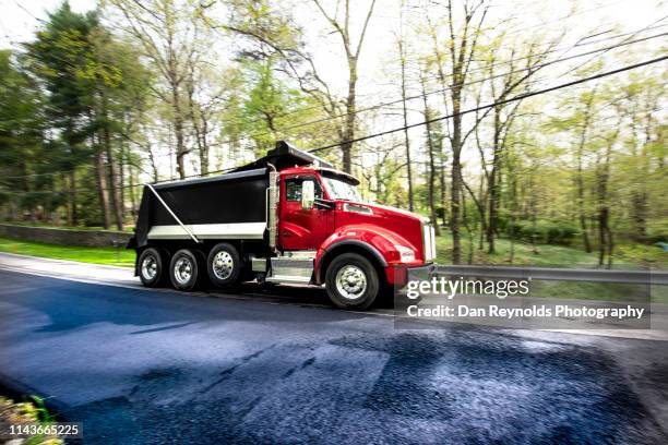 blacktop road with dump truck - dumper truck foto e immagini stock
