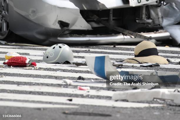 Helmet for child and a straw hat remain at an accident site where a car driven by a 87-year-old man ploughed into pedestrians and hit a dust cart...