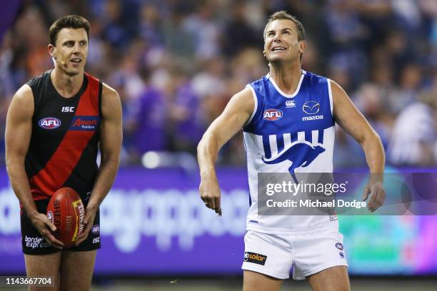 Bombers legend Matthew Lloyd and Kangaroos legend Wayne Carey take part in the Kick For The Kids fundraiser during the round 5 AFL match between...