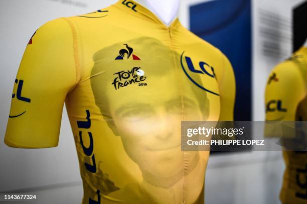 Picture taken in Romilly-sur-Seine on May 14, 2019 shows one of the yellow jersey of the Tour de France 2019, bearing a portrait of French cycling...