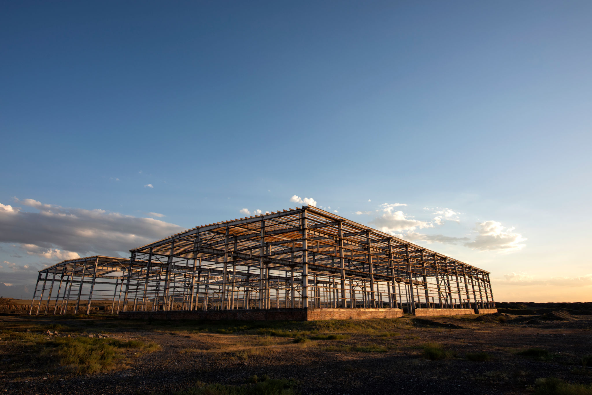 The building's steel structure is set against the dusk sky The building's steel structure is set against the dusk sky
