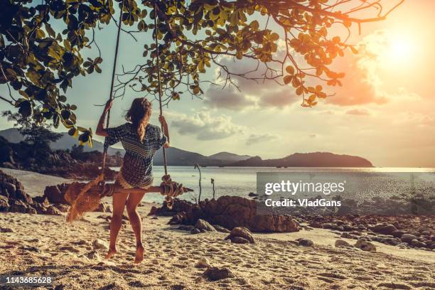 woman at tropical swing - beige hat stock pictures, royalty-free photos & images