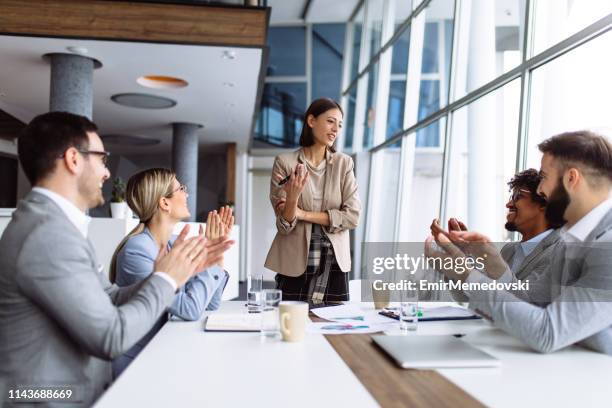 group of business people applauding team leader after presentation - applauding staff stock pictures, royalty-free photos & images