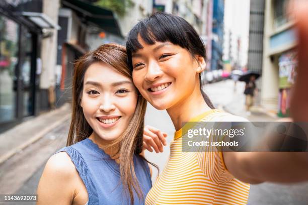 beautiful women taking a self portrait in hong kong - beautiful chinese girls stock pictures, royalty-free photos & images