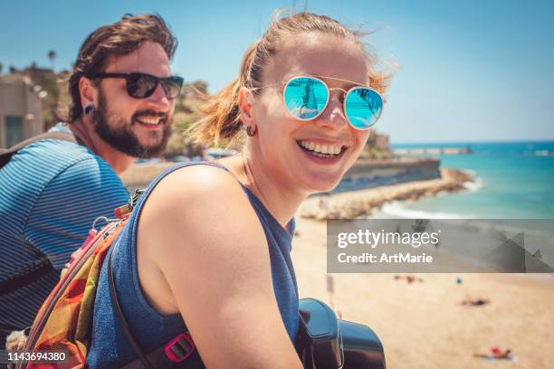 young cute man and woman happy to reach the sea - israel travel stock pictures, royalty-free photos & images