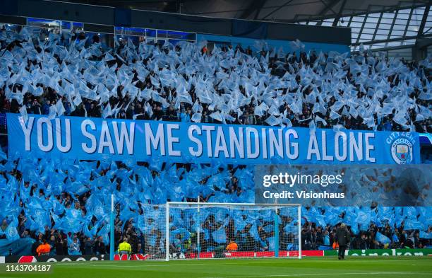 Manchester City fans wave flags and a banner saying You Saw Me Standing Alone from the song Blue Moon before the UEFA Champions League Quarter Final...