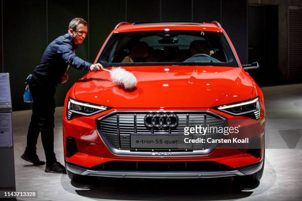 Staff member cleans an Audi e.tron 55 Quattro during the Volkswagen AG company's annual shareholders' meeting on May 14, 2019 in Berlin, Germany....