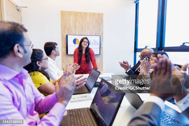 successful businesswoman applauded by her colleagues - cultures stock pictures, royalty-free photos & images
