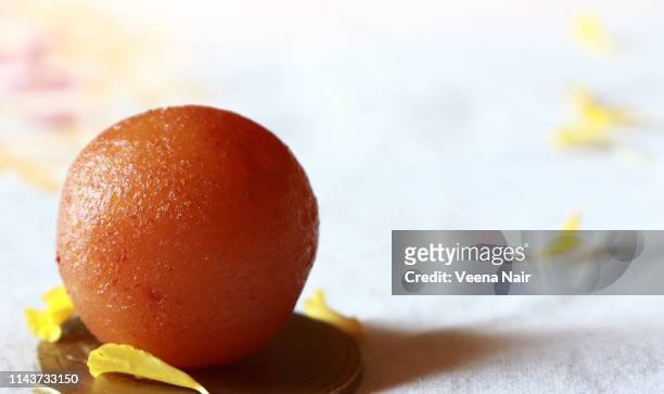 a single gulab jamun/indian dessert  against white background - gulab jamun stock pictures, royalty-free photos & images