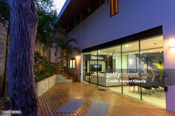maison de luxe moderne au crépuscule - porte d'accès à la terrasse photos et images de collection