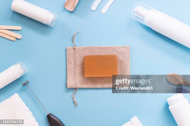 kit to make your own cosmetics, cream, gunny bag and soap on blue background - washcloth stockfoto's en -beelden