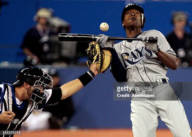 Upton of the Tampa Bay Rays gets hit by a Jesse Litsch pitch in front of J.P. Arencibia of the Toronto Blue Jays during MLB action at the Rogers...