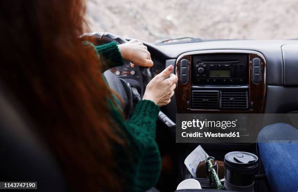 back view of woman driving car on mountian road - bergstrecke stock-fotos und bilder