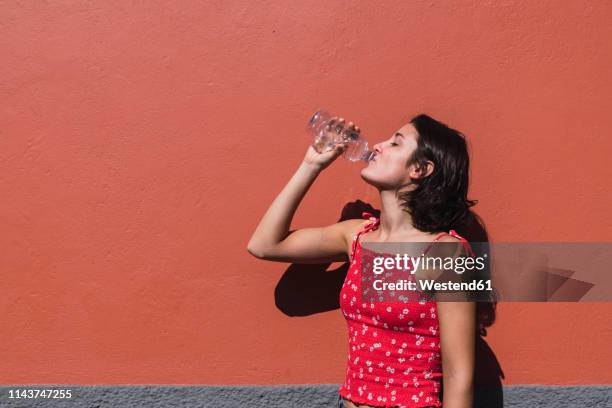 young woman drinking water - hot spanish women ストックフォトと画像